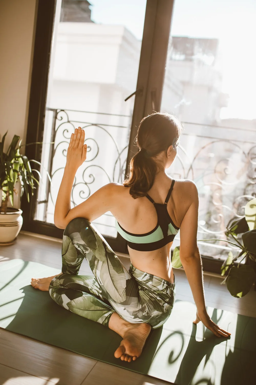 A woman practicing yoga at home