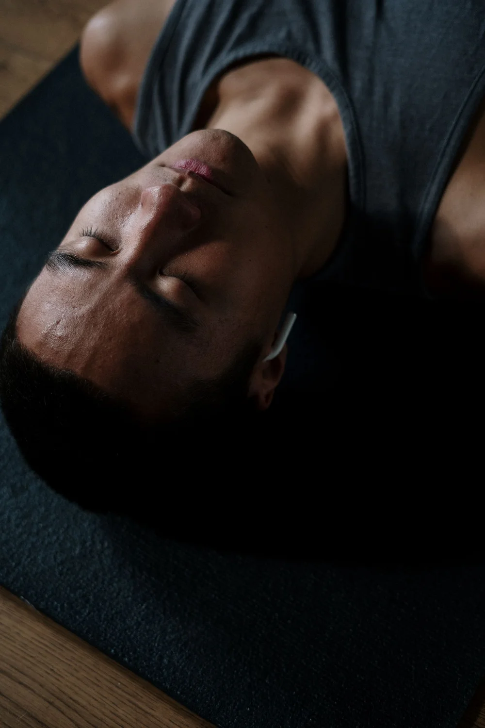 A yoga practitioner resting on a mat